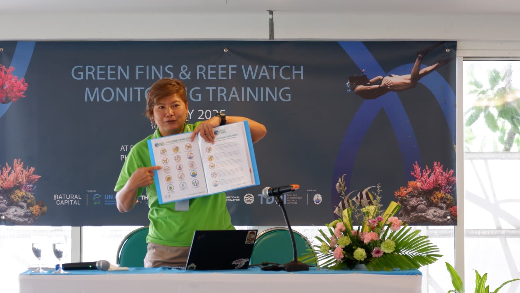 A Green Fins trainer presenting the Green Fins environmental icons during the Reef Watch training session